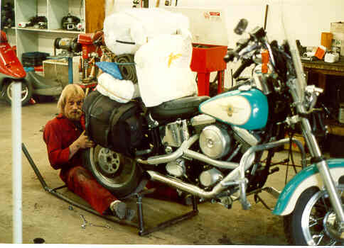 Rod Johnson changing Serena's tire in his shop in Grand Prairie